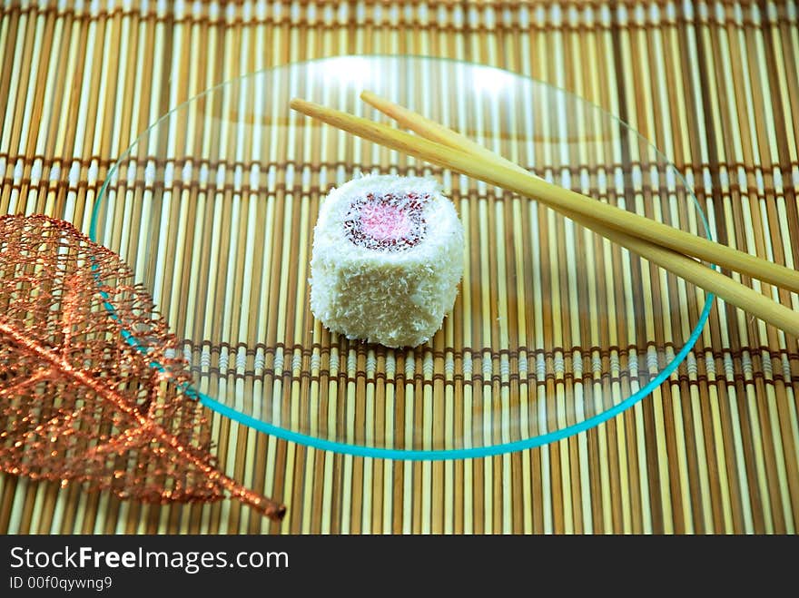 Beautiful cake in a plate on a bamboo napkin