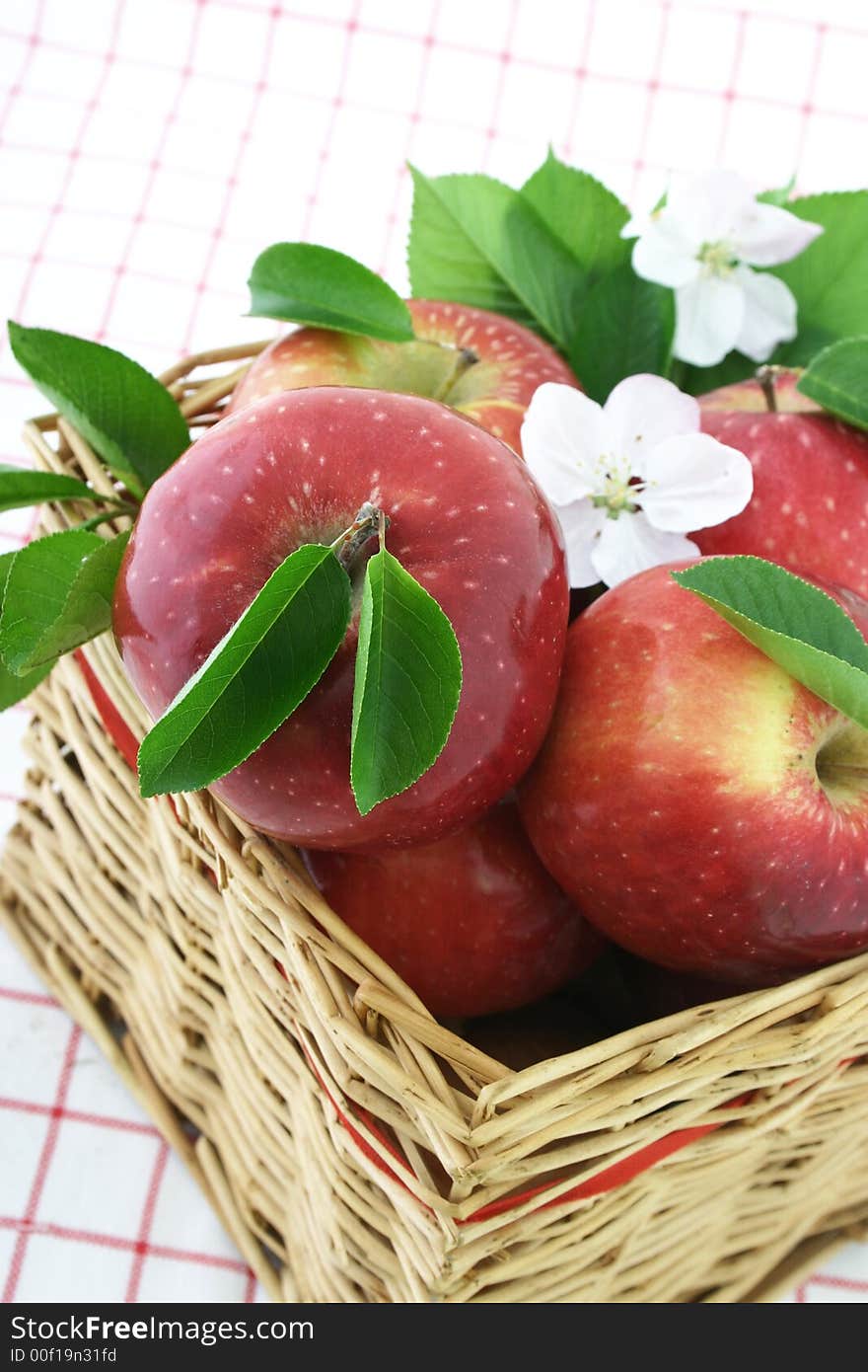 Red apples and white flower in a basket. Red apples and white flower in a basket