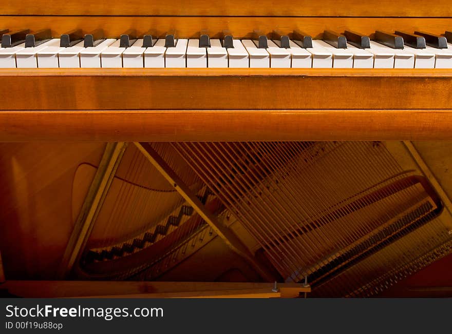 The keyboard and inside workings of a piano. The keyboard and inside workings of a piano.