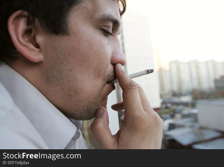 The man with cigarette in the evening. The man with cigarette in the evening