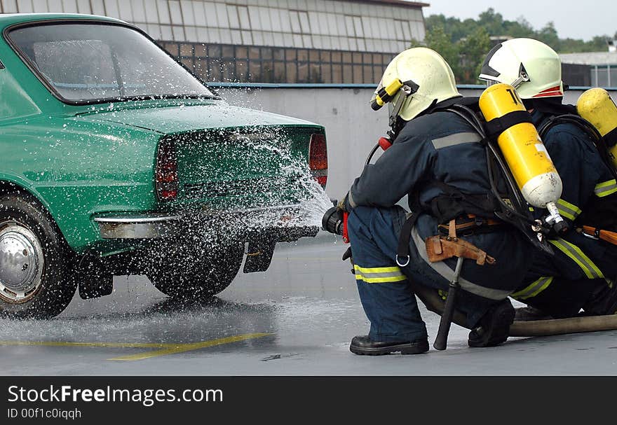 Firemen fighting the fire in parking house