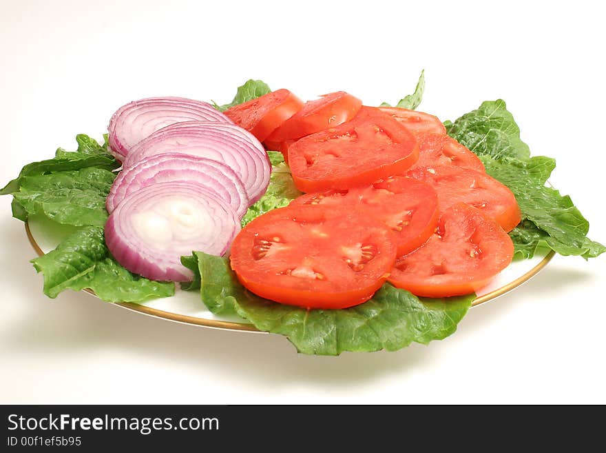 Isolated photo of a sliced tomato and onion on white