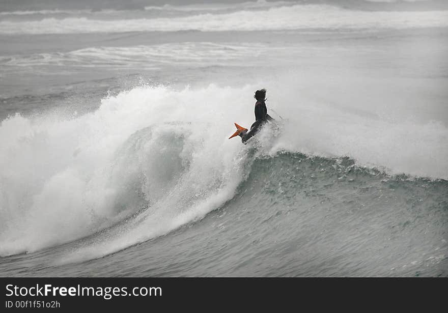 Photo of a bodyboarder on top of the wave