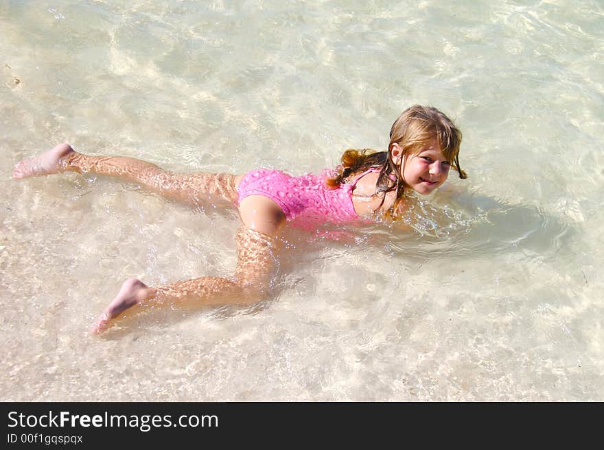 Small girl swimming in the clear water. Small girl swimming in the clear water