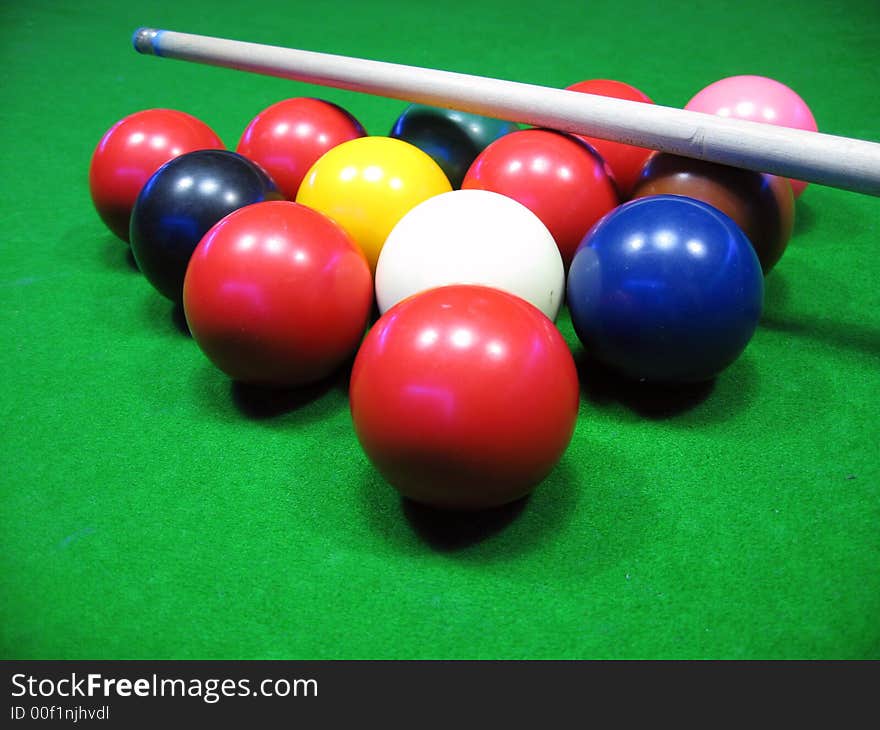 Billiards balls on a green table,billiard table and balls and cue