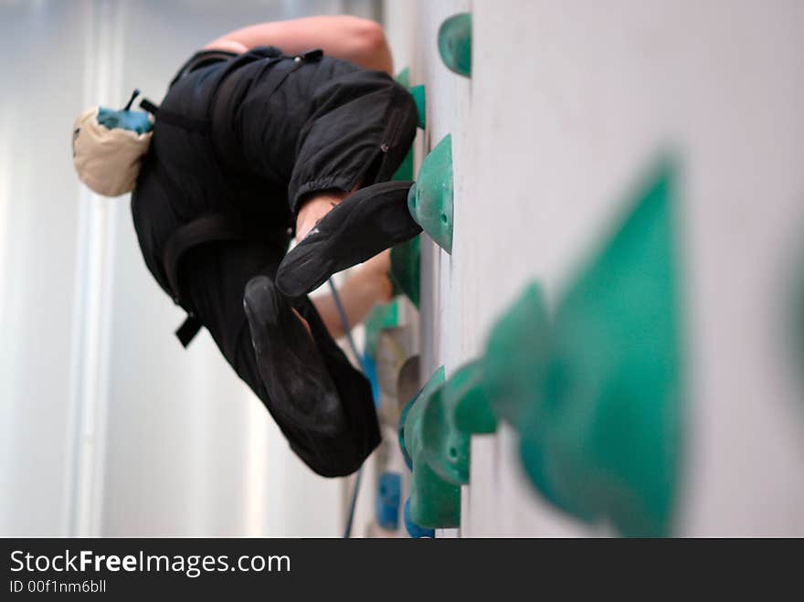 Rock-climber training on the artificial wall. Rock-climber training on the artificial wall