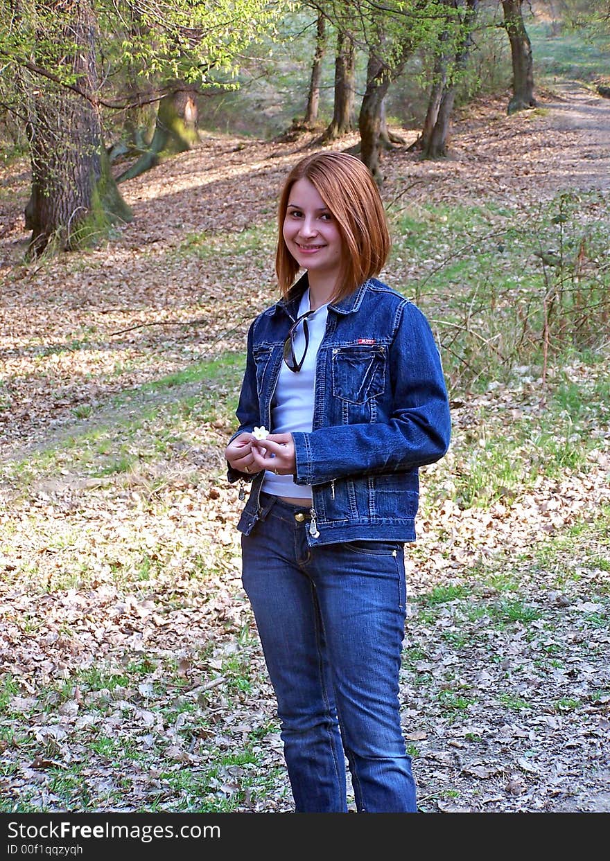 Cute young girl with a flower in her hand. Cute young girl with a flower in her hand