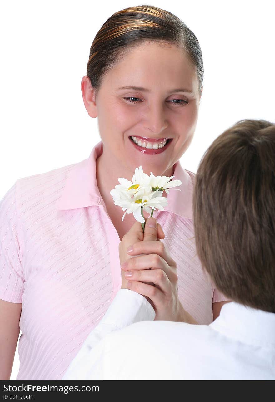 Boy giving daisies to his mom, focus on mother, isolated on white. Boy giving daisies to his mom, focus on mother, isolated on white