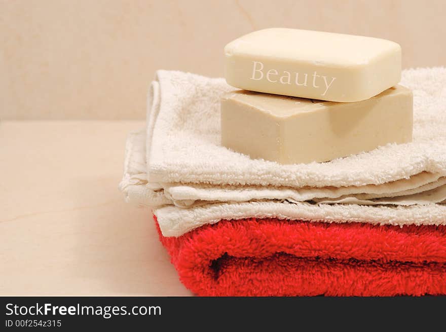 Red and white towels and honey soaps in spa bathroom (spa concept )