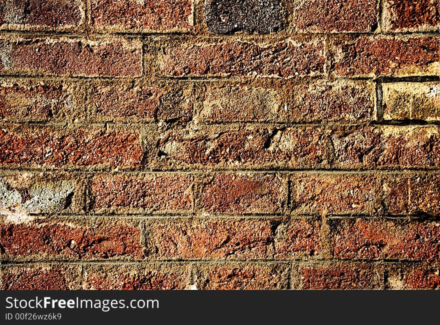 Old damaged weathered brick wall. Old damaged weathered brick wall