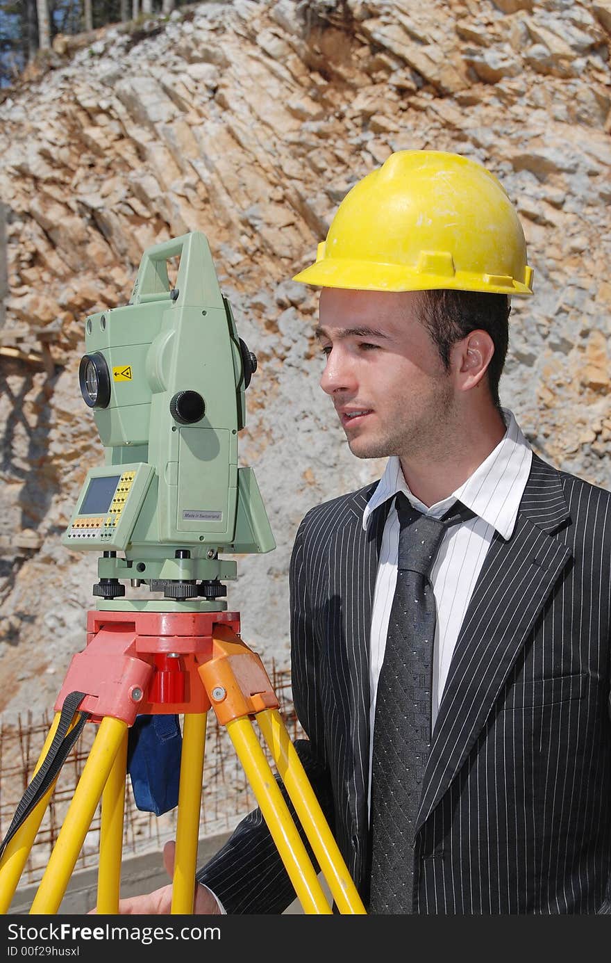 Boss with yellow helmet measuring distance. Boss with yellow helmet measuring distance