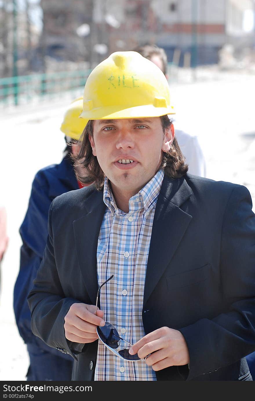 Boss wearing yellow helmet on a construction site. Boss wearing yellow helmet on a construction site