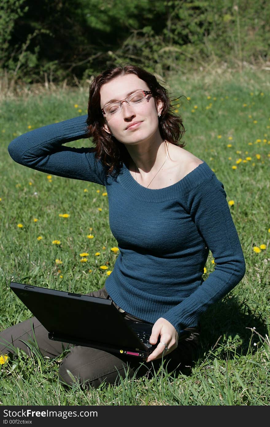 Beauty woman work with notebook in a grass. Beauty woman work with notebook in a grass