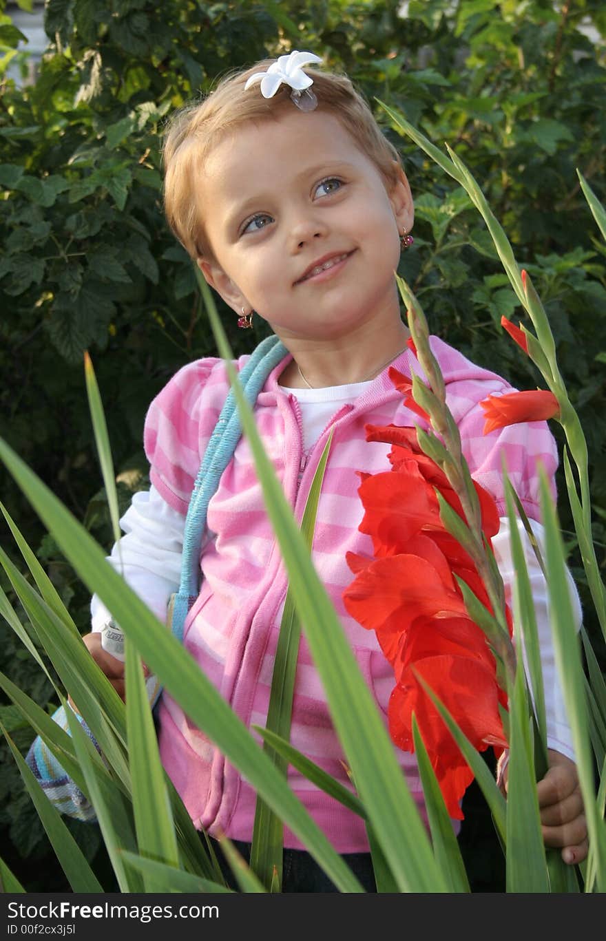 Little girl with flower in summer day