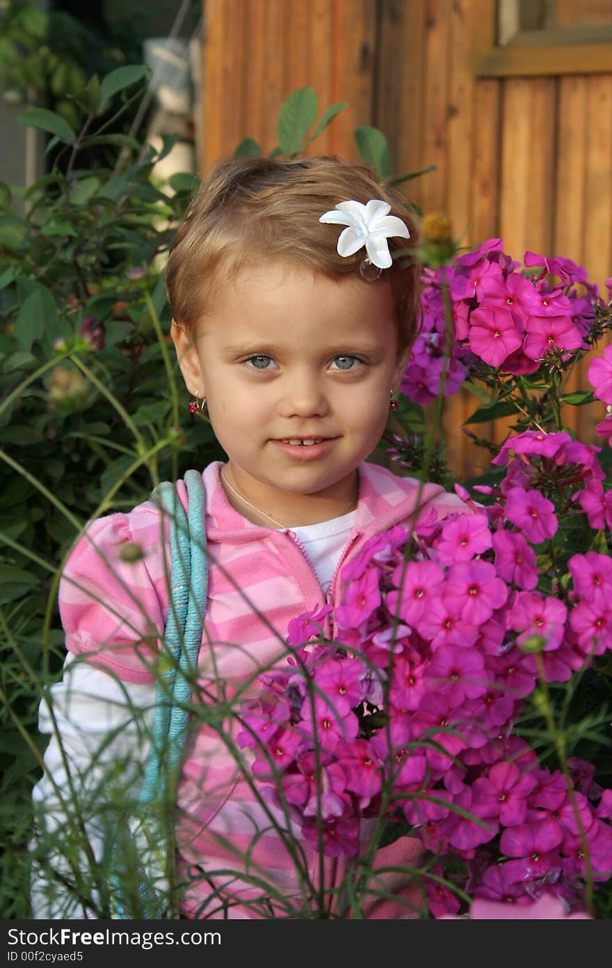 Little girl with flower in summer day