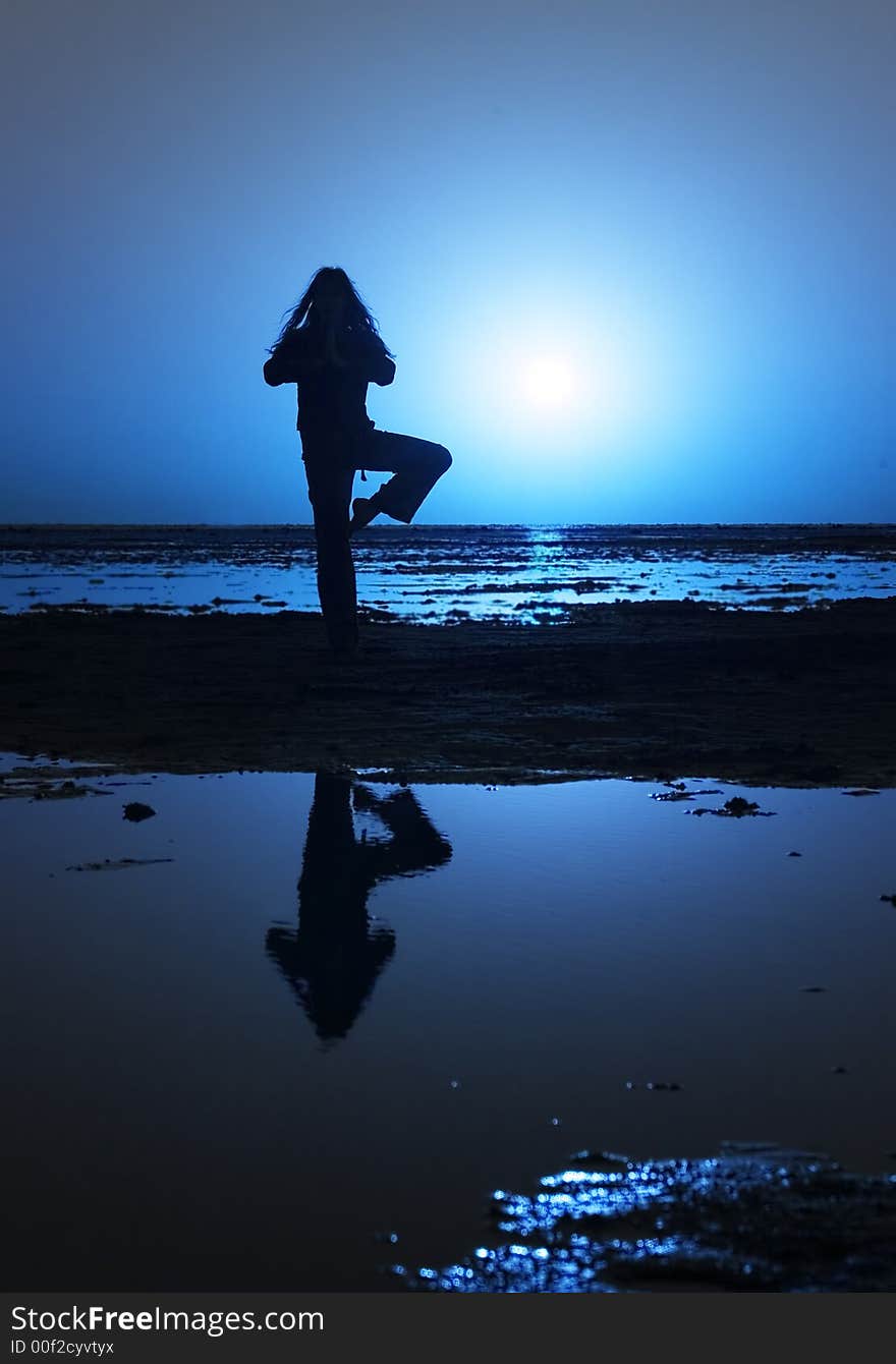 Woman streching on the shore. Woman streching on the shore