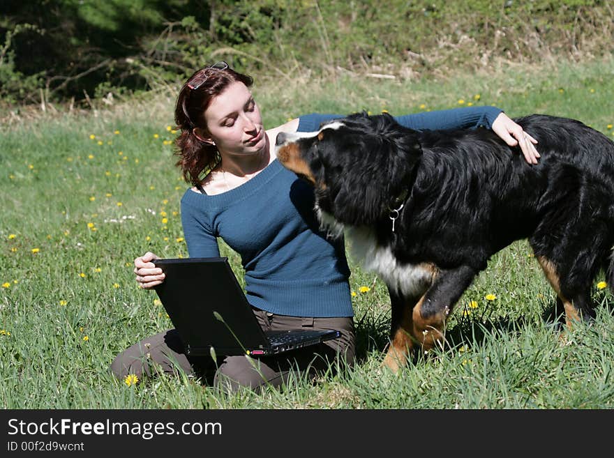 Beauty woman work with notebook in a grass. Beauty woman work with notebook in a grass