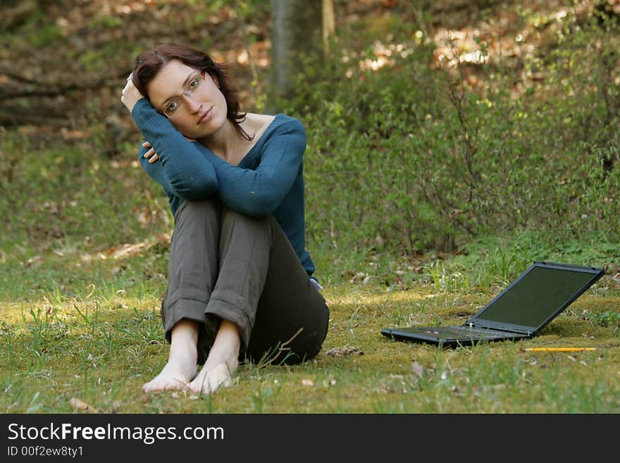 Beauty woman work with notebook in a grass. Beauty woman work with notebook in a grass