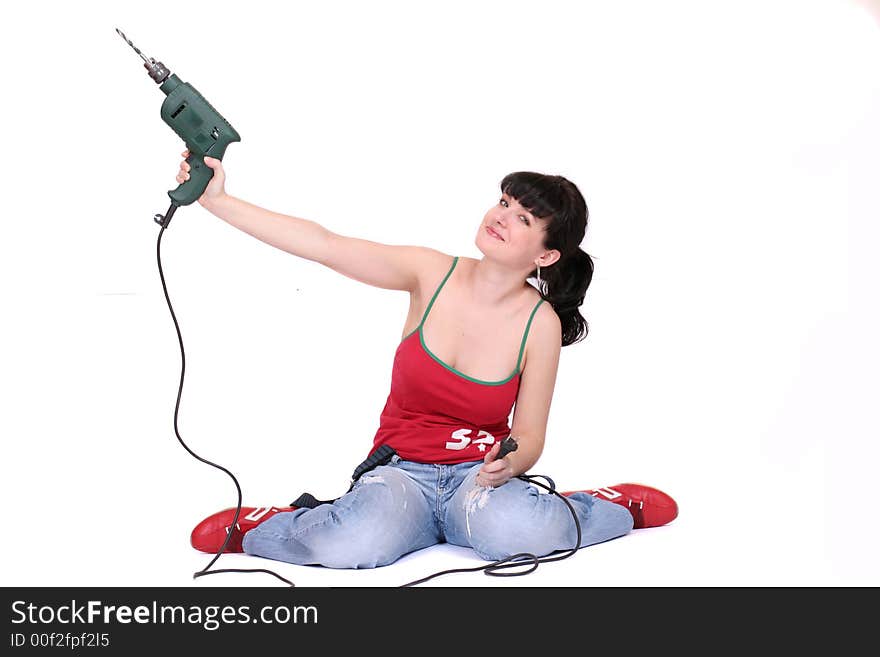 A woman holds a lifted drill. White background. A woman holds a lifted drill. White background.