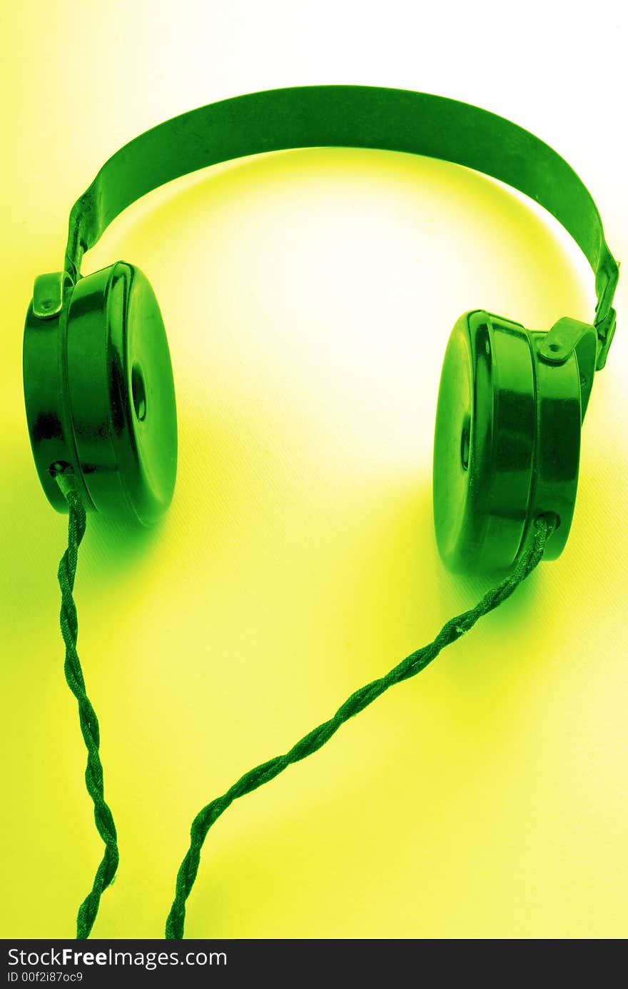 Old headphones on  green background