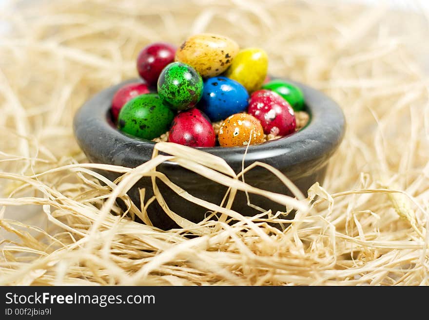 Colorful eggs in bowl