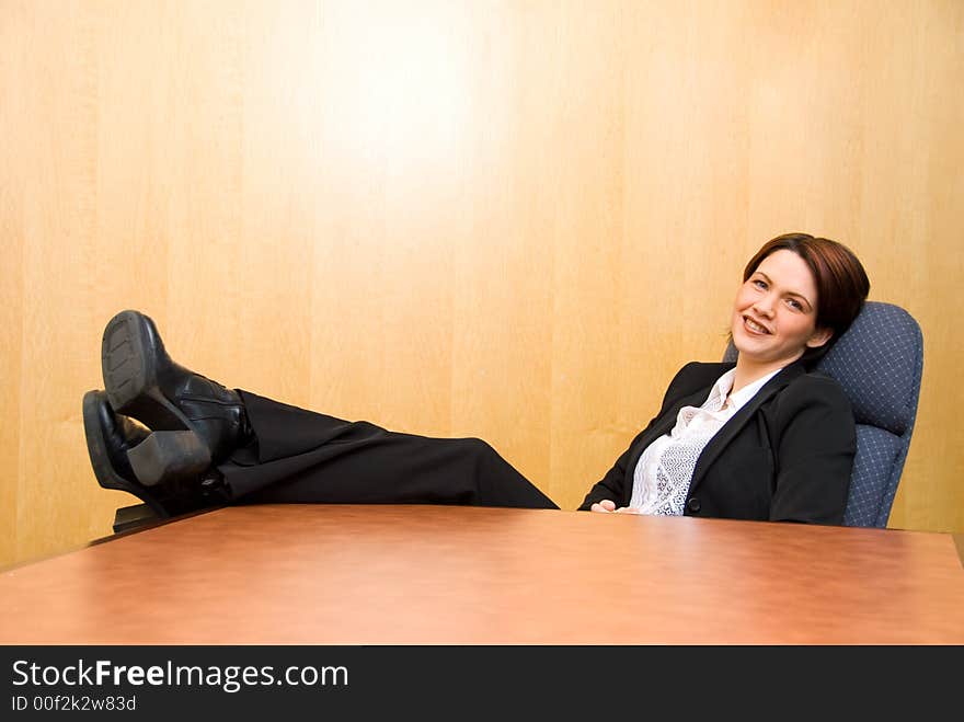 Business woman with her feet up on the table. Business woman with her feet up on the table