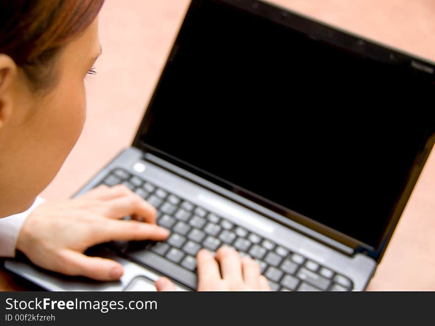 Woman in a meeting typing on her laptop