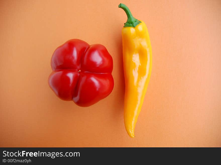 Red and yellow pepper on orange, healthy diet, vegetables