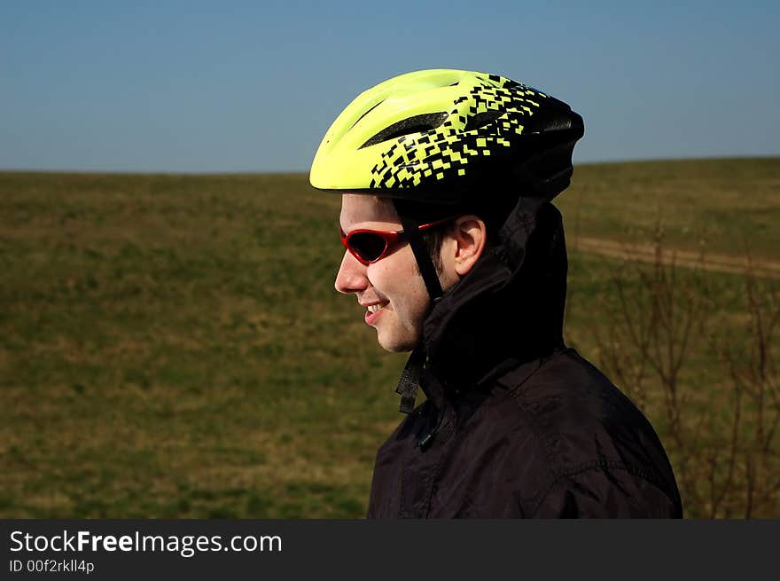 Photo of mountain biker in sporting costume with helmet. Photo of mountain biker in sporting costume with helmet.