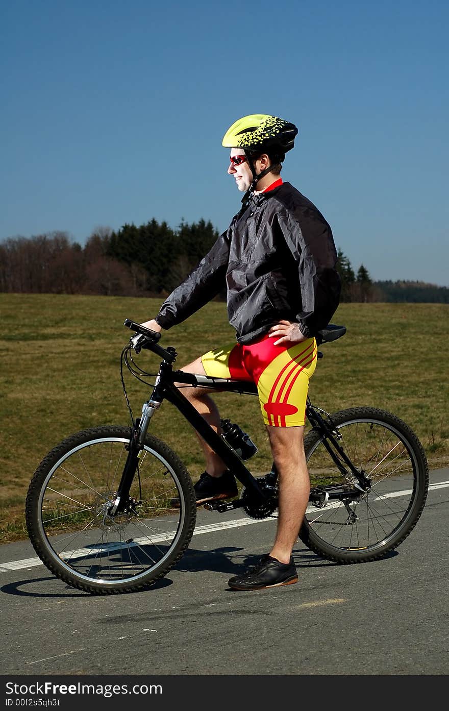 Photo of mountain biker in sporting costume with helmet. Photo of mountain biker in sporting costume with helmet.