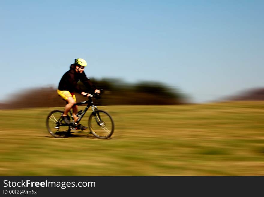 Photo of mountain biker in sporting costume with helmet. Photo of mountain biker in sporting costume with helmet.