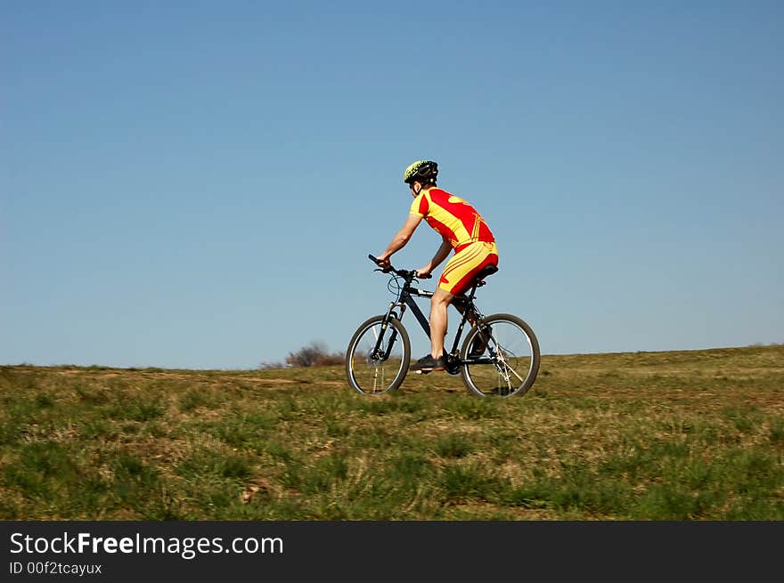 Photo of mountain biker in sporting costume with helmet. Photo of mountain biker in sporting costume with helmet.