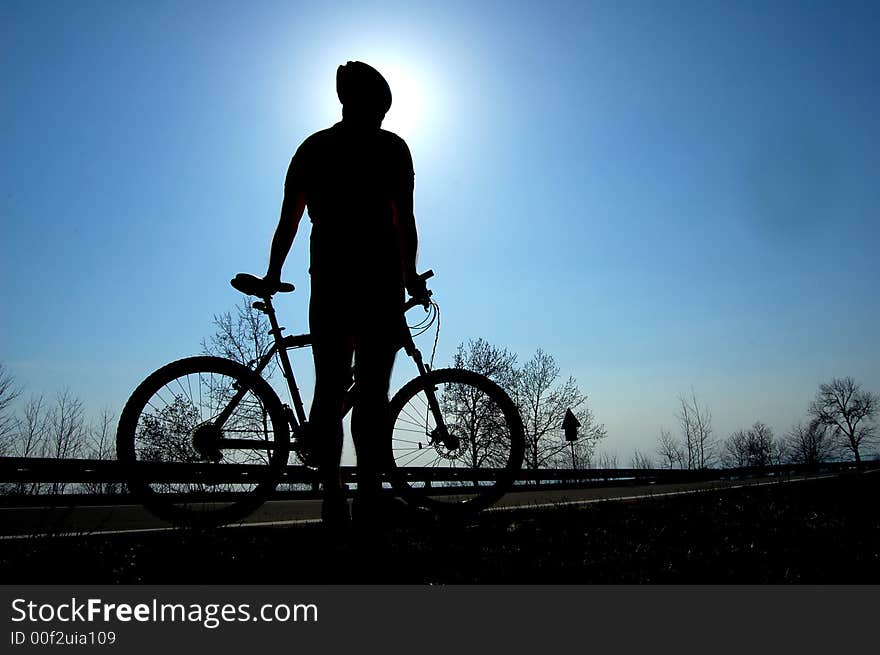 Photo of mountain biker silhouette. Photo of mountain biker silhouette.