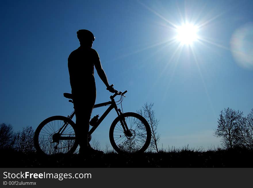 Photo of mountain biker silhouette. Photo of mountain biker silhouette.