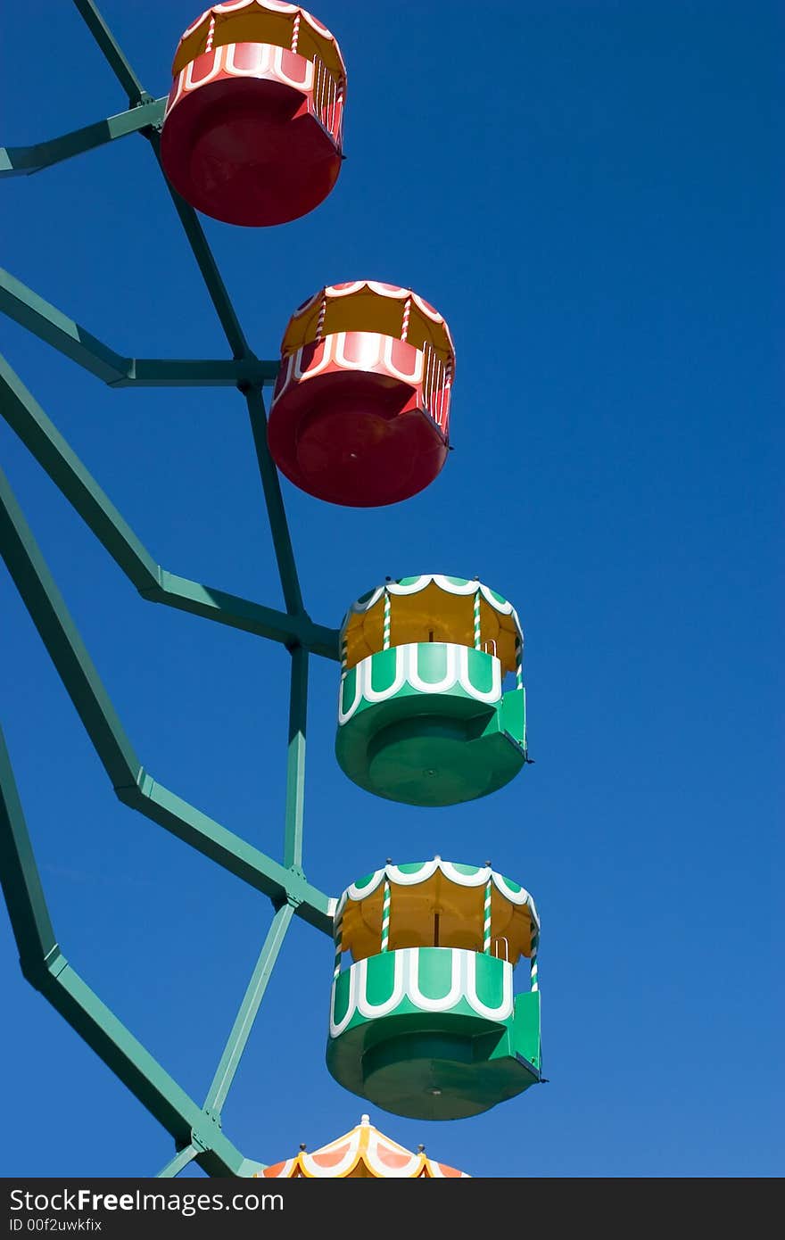 A multi-colored ferris wheel against a clear blue sky

<a href=http://www.dreamstime.com/search.php?srh_field=play&s_ph=y&s_il=y&s_sm=all&s_cf=1&s_st=wpo&s_catid=&s_cliid=301111&s_colid=&memorize_search=0&s_exc=&s_sp=&s_sl1=y&s_sl2=y&s_sl3=y&s_sl4=y&s_sl5=y&s_rsf=0&s_rst=7&s_clc=y&s_clm=y&s_orp=y&s_ors=y&s_orl=y&s_orw=y&x=43&y=5> See more playfull pictures </a>