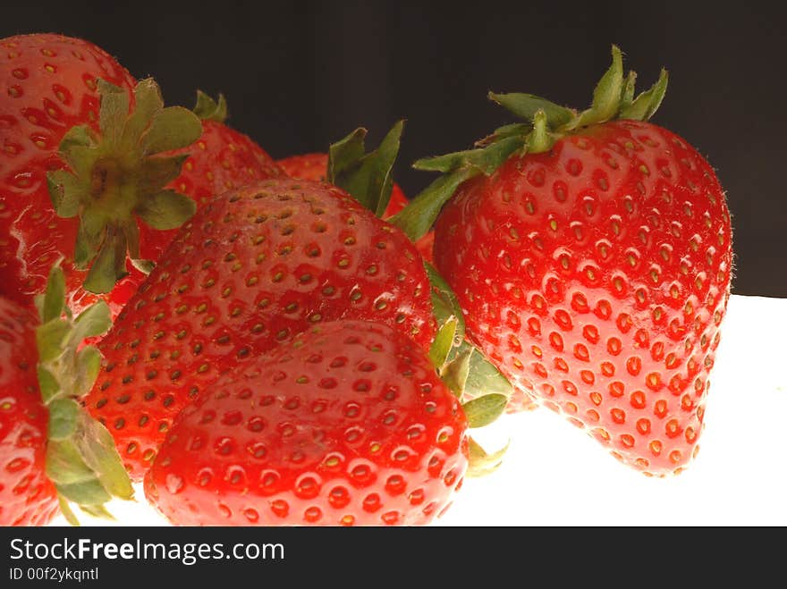 Red strawberries with black background. Red strawberries with black background