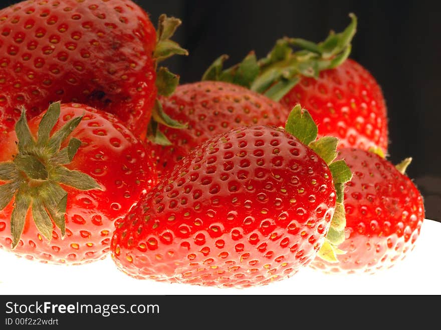 Red strawberries with black background. Red strawberries with black background