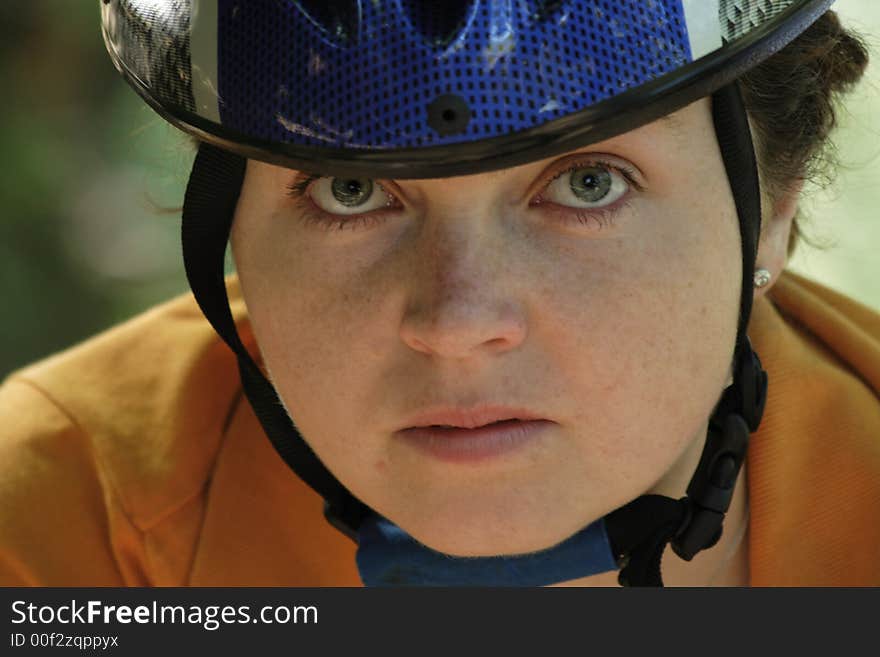 A beautiful gir with blue helmet go by bicycle. A beautiful gir with blue helmet go by bicycle