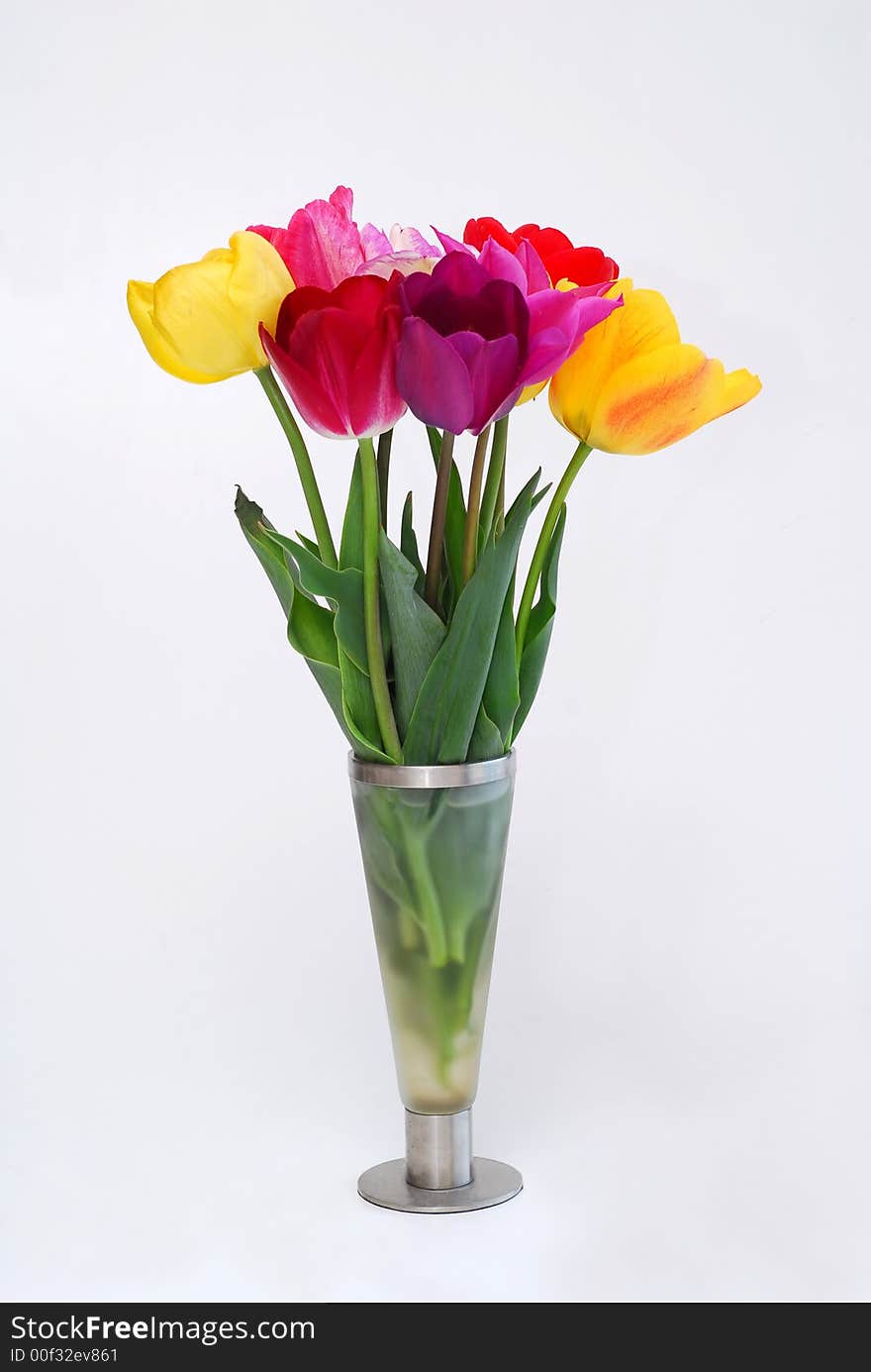 Glass vase with bunch of tulips in it. Glass vase with bunch of tulips in it