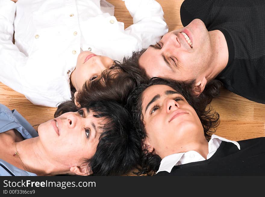 Happy family spending time together on hard wood floor. Happy family spending time together on hard wood floor