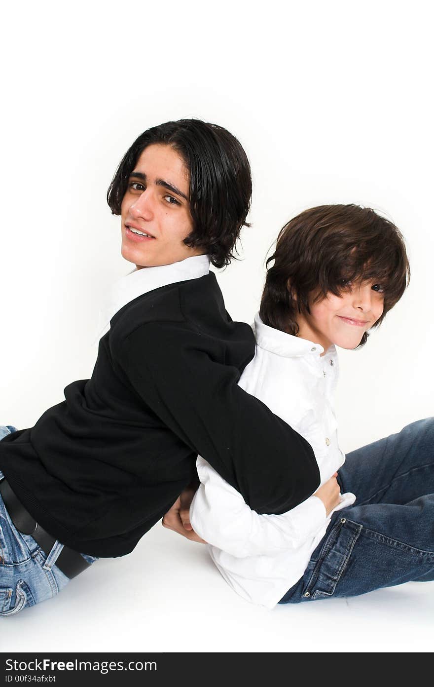 Brothers spending time and posing together over white background. Brothers spending time and posing together over white background