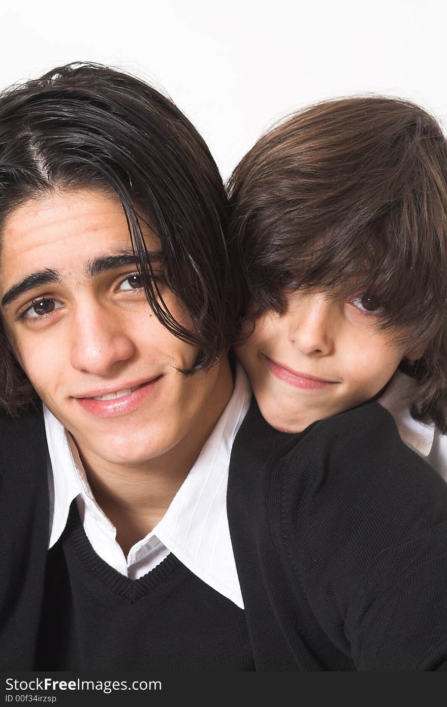 Brothers spending time and posing together over white background. Brothers spending time and posing together over white background