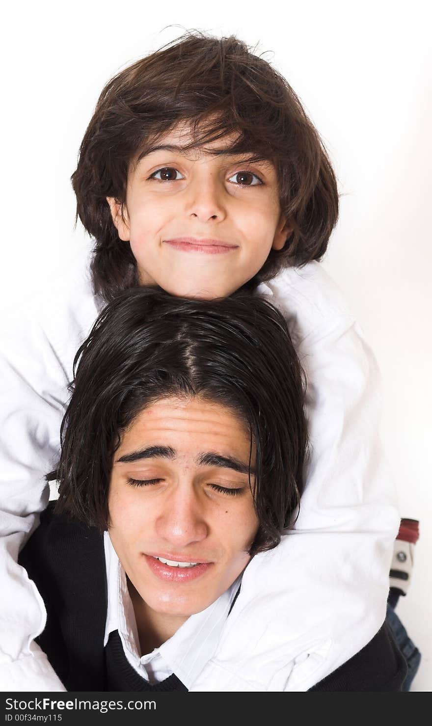 Brothers spending time and posing together over white background. Brothers spending time and posing together over white background