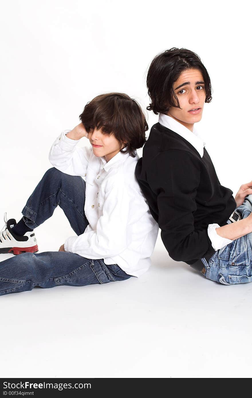 Brothers spending time and posing together over white background. Brothers spending time and posing together over white background