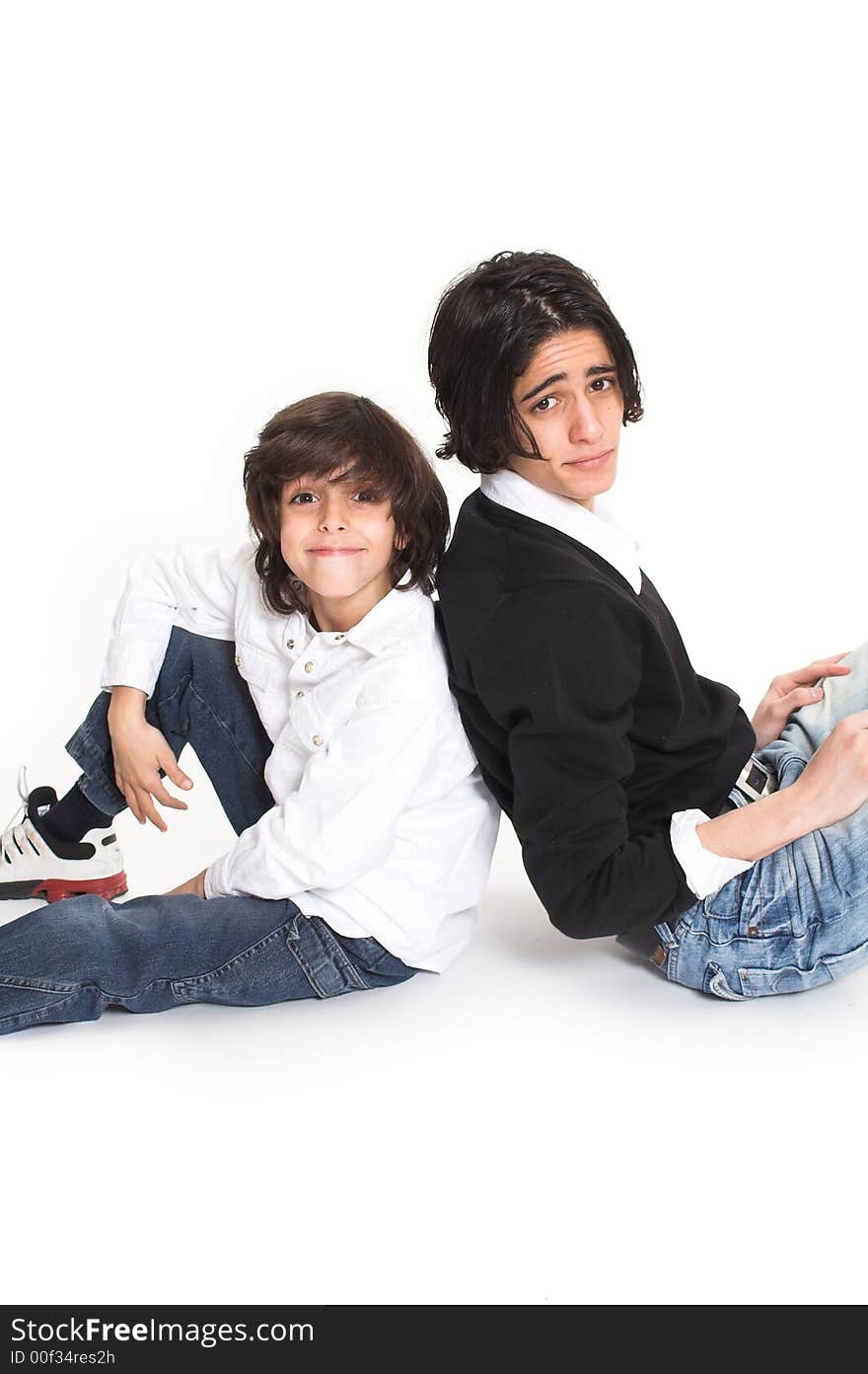 Brothers spending time and posing together over white background. Brothers spending time and posing together over white background