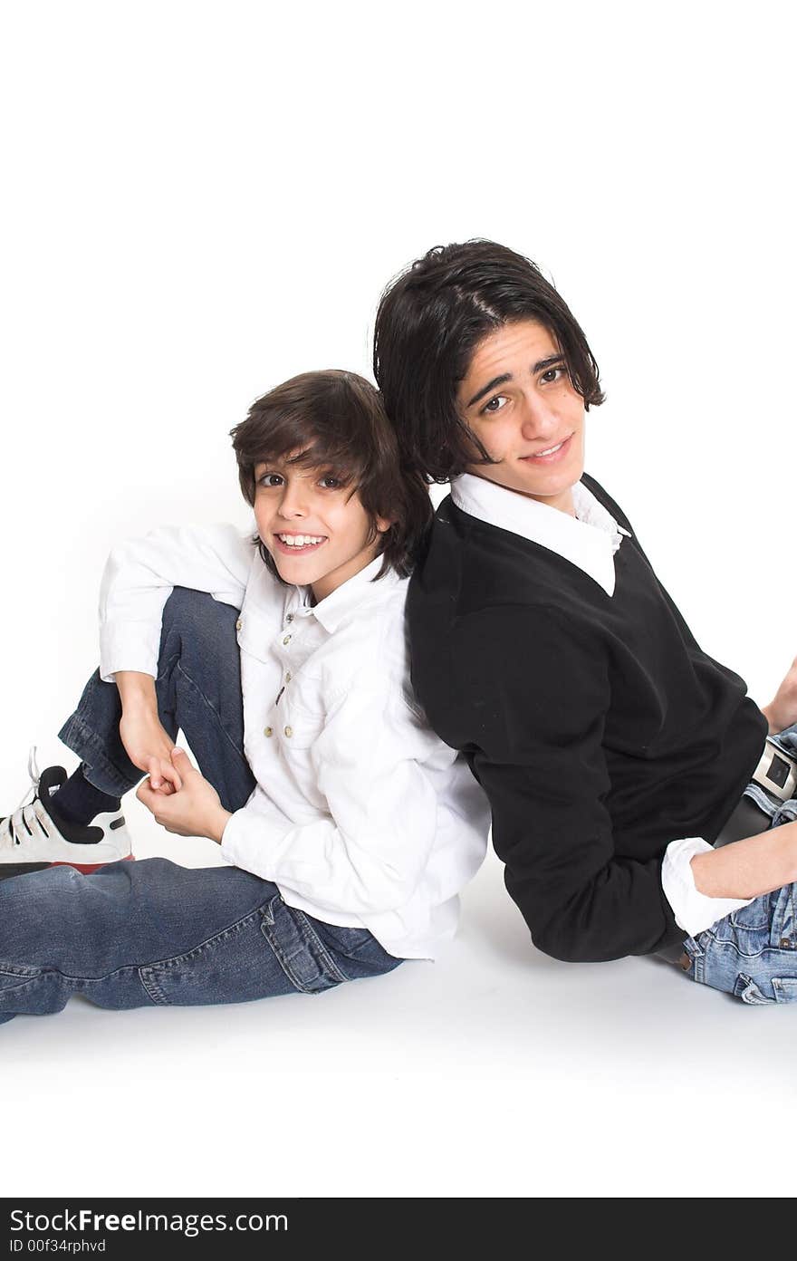 Brothers spending time and posing together over white background. Brothers spending time and posing together over white background