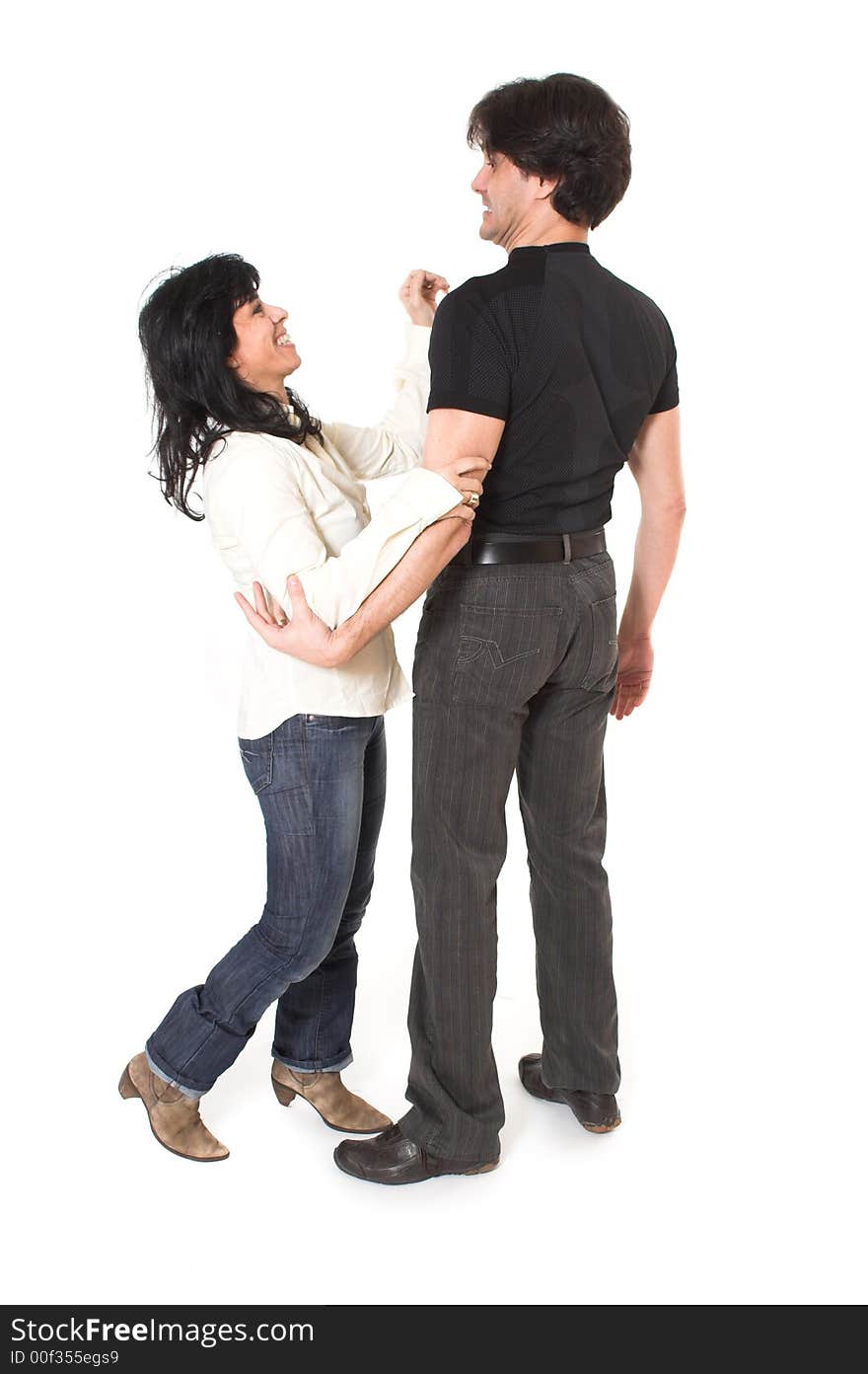 Portrait of happy couple cuddling over white background