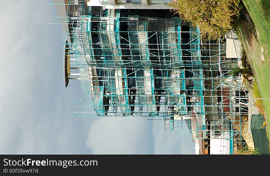 A building under construction with scaffolding. A building under construction with scaffolding