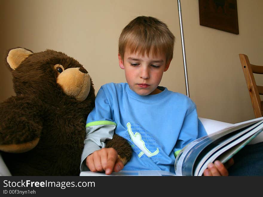 Little boy is reading interesting book. Little boy is reading interesting book