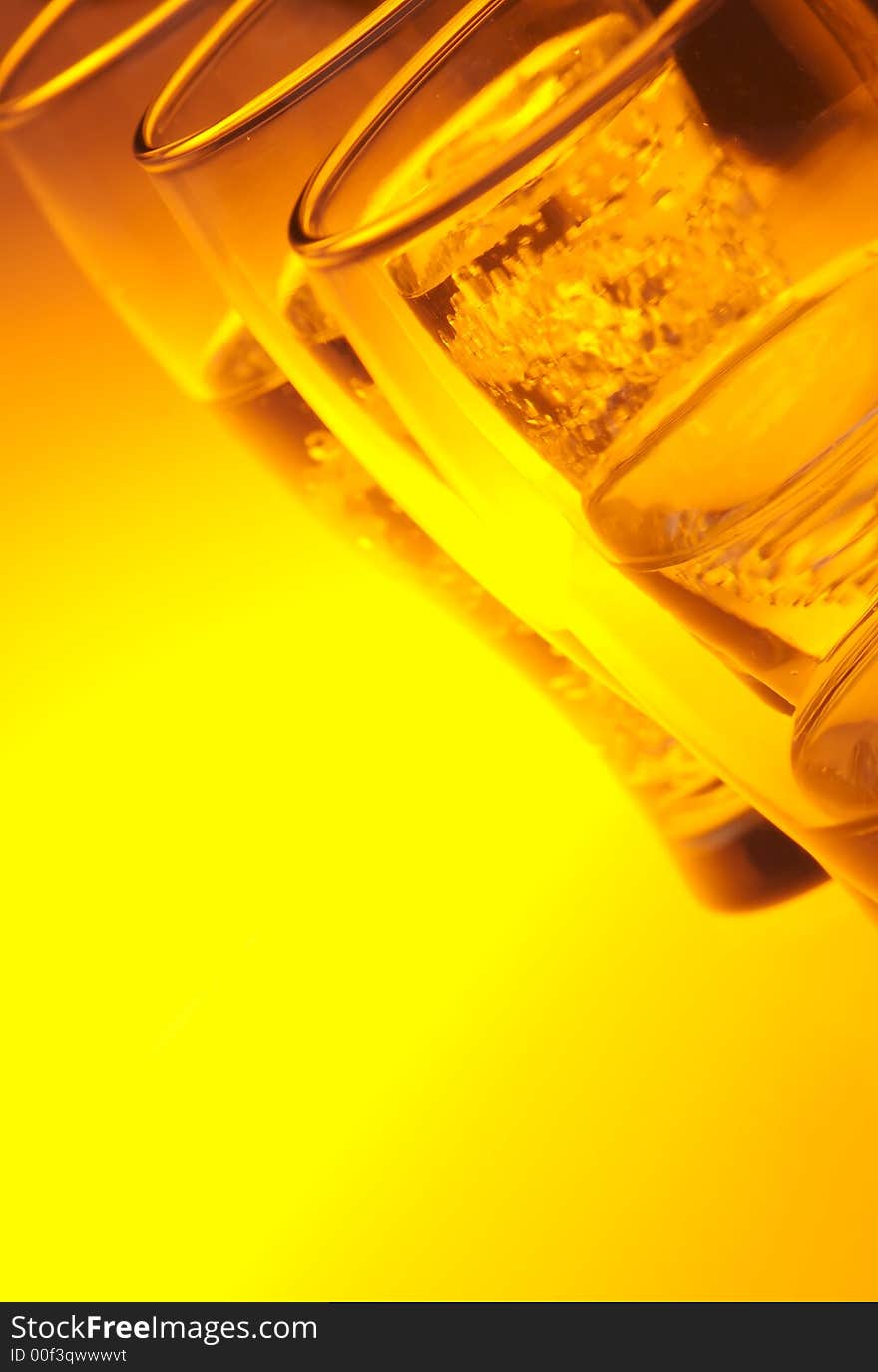 Liquid filled glasses with yellow back lighting.